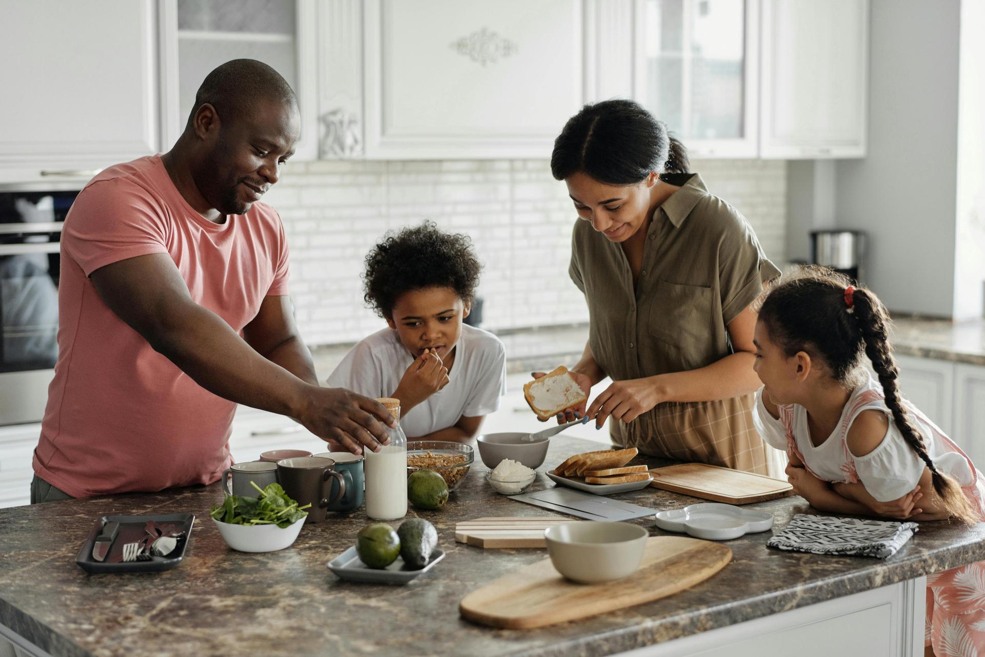 Family having fun while preparing a meal in a clean, modern kitchen